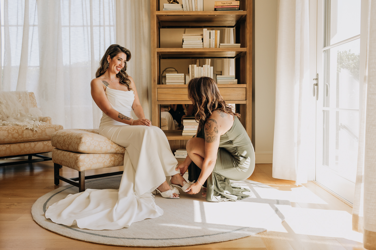 Mother putting shoes on bride